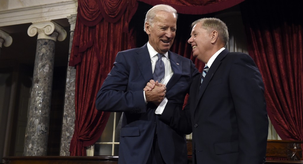 Vice President Joe Biden shares a laugh with Sen. Lindsey Graham, R-S.C. before Biden administered the Senate oath during a ceremonial re-enactment swearing-in ceremony, Tuesday, Jan. 6, 2015, in the Old Senate Chamber on Capitol Hill in Washington. (AP Photo/Susan Walsh)