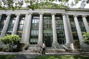 A bicyclist walks by Langdell Hall, the Harvard Law Library, on the campus of the Harvard Law School in Cambridge, Mass., Monday, Aug. 1, 2005.  Black-robed for two centuries, the Supreme Court justices could be sporting a new color next term: crimson.  That would be to honor Harvard Law School, which if John Roberts is confirmed, could make an unprecedented boast: five of its graduates serving on the high court simultaneously. A sixth justice, Ruth Bader Ginsberg, attended Harvard Law but finished her degree at Columbia.   (AP Photo/Charles Krupa)